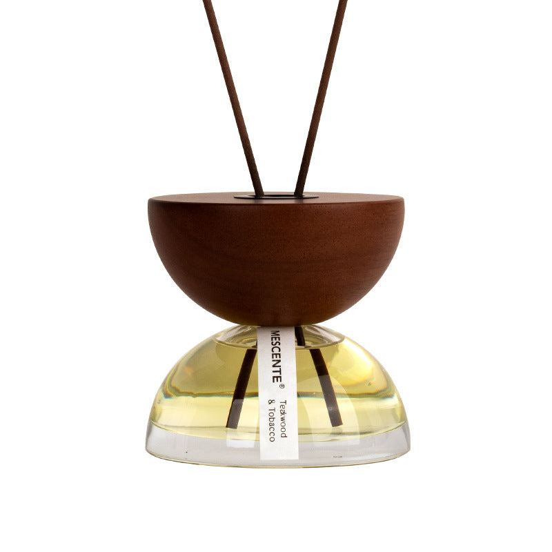 Elegant hourglass aroma diffuser with essential oil fragrance in modern bedroom