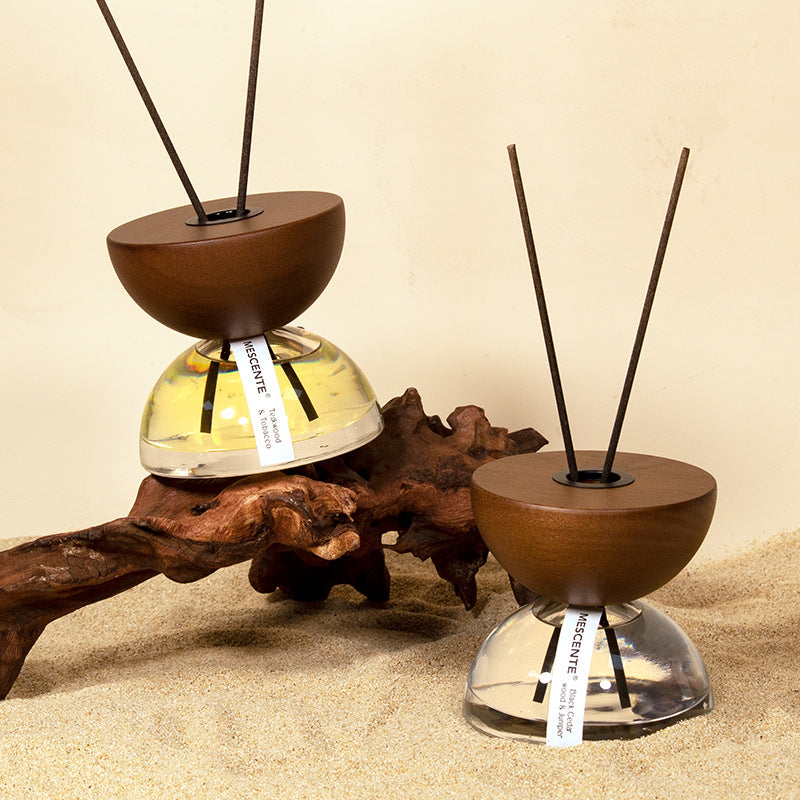 Hourglass fire-free aromatherapy diffuser in luxury neutral bedroom setting