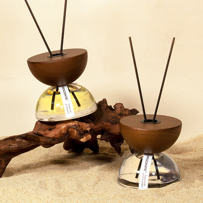 Hourglass fire-free aromatherapy diffuser in luxury neutral bedroom setting