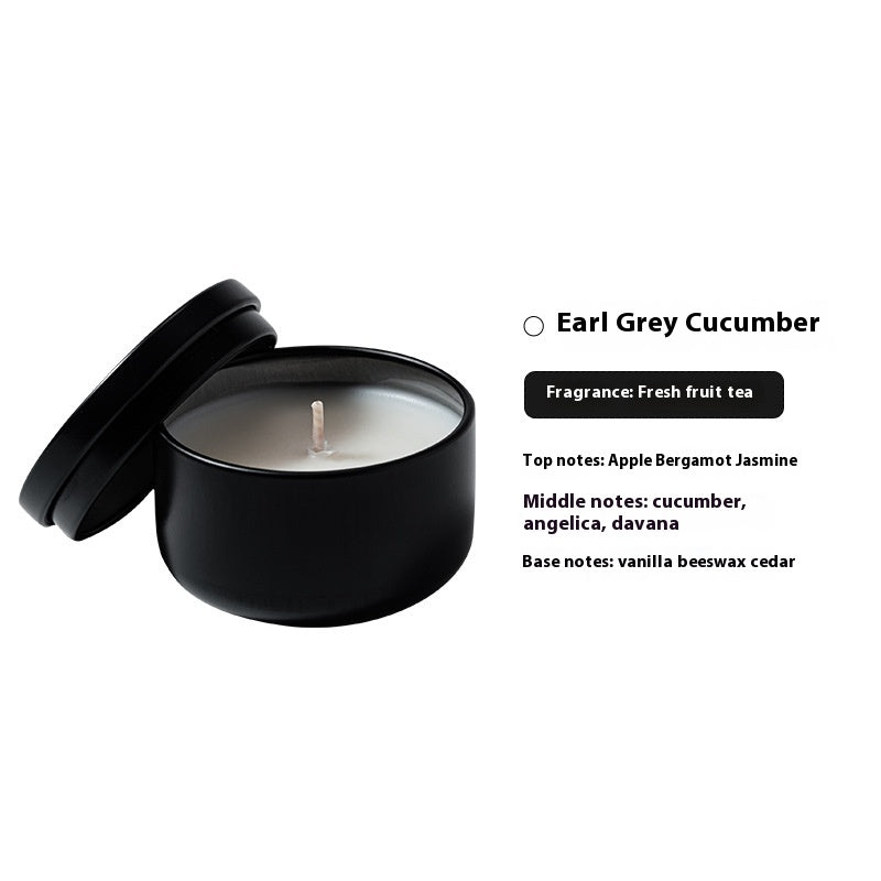 Black candle with lid on a white background, featuring product details.